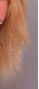 The ends of hair colored orange and blonde.